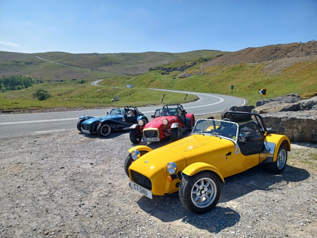Gnu (the yellow Caterham 7 in the foreground) on the Black Mountains Road, Brecon Beacons, Wales. There are two other Caterham 7's in the background.